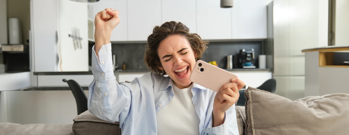 Young woman laughing as she takes a selfie